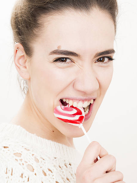 istock Attractive brunette who bites a lollipop 507708404