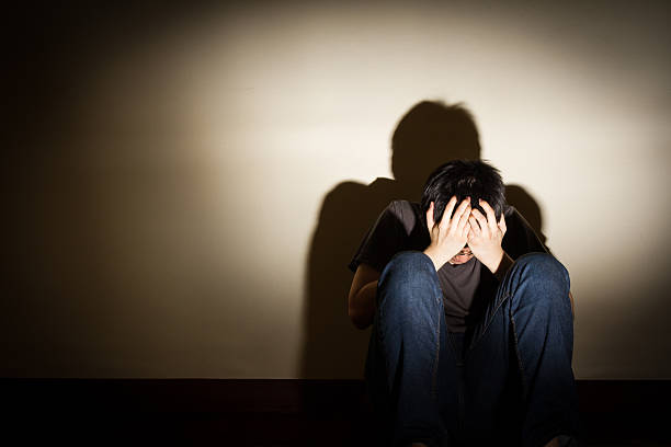 istock depressed despaired young man sit on the floor 507708600