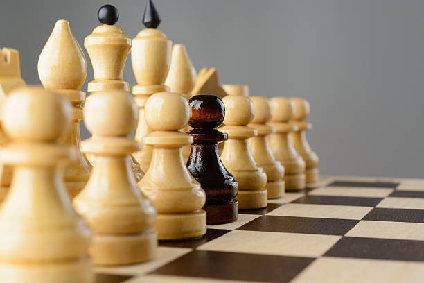 istock Black pawn among white pieces 507708824