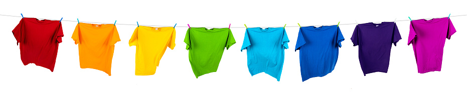Assorted items of clothing drying on a clothes line, outdoors.