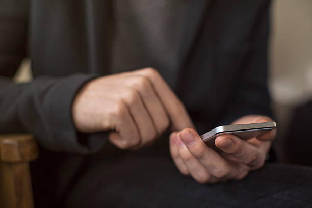 istock Close up of young man using a smart phone 507710422