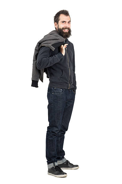 Laughing hipster with pierced lips holding jacket over the shoulder