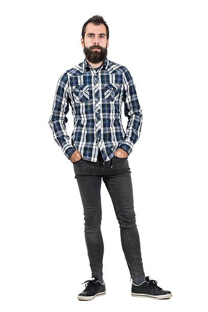 istock Confident serious hipster in plaid shirt with hands in pockets 507711038