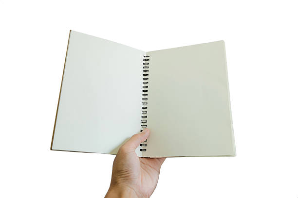 istock Hand holding opened notebook, isolated on white background 507711304