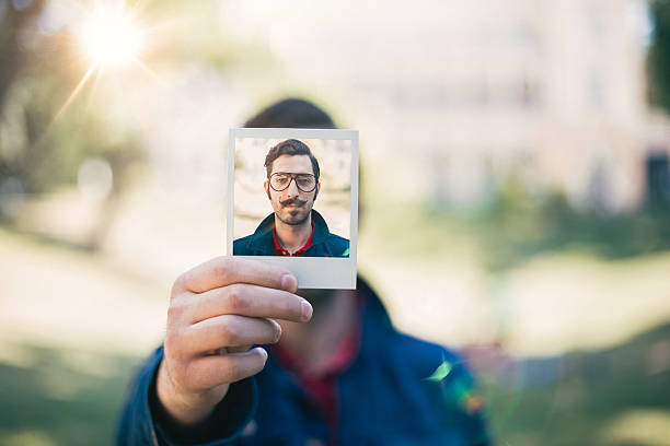 istock Man holding instant selfie 507711466