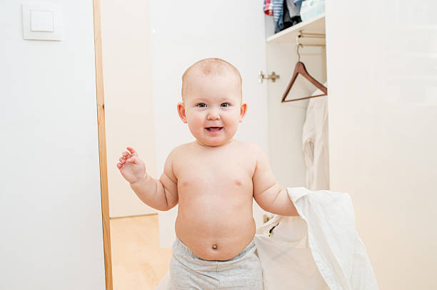 istock little child trying on clothes 507713900