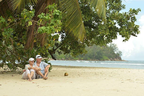 istock Elderly couple sitting on a bench outdoors 507714082