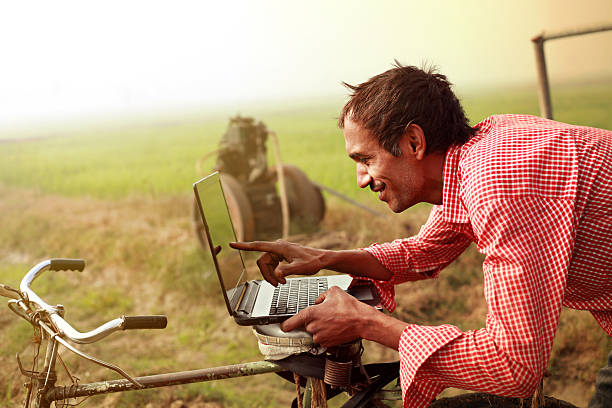 Farmer using laptop in the field