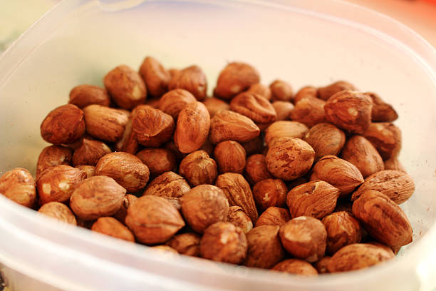 Bowl full of tasty and healthy hazelnuts stock photo