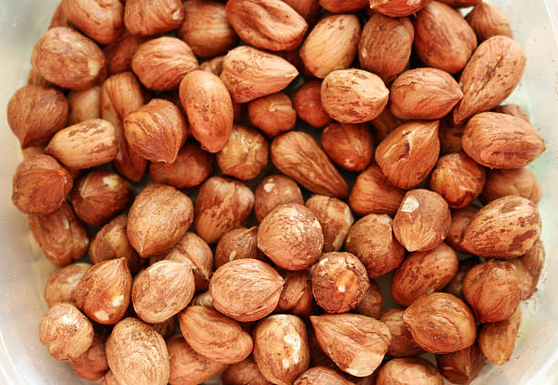 Tasty and healthy hazelnuts in bowl from above stock photo