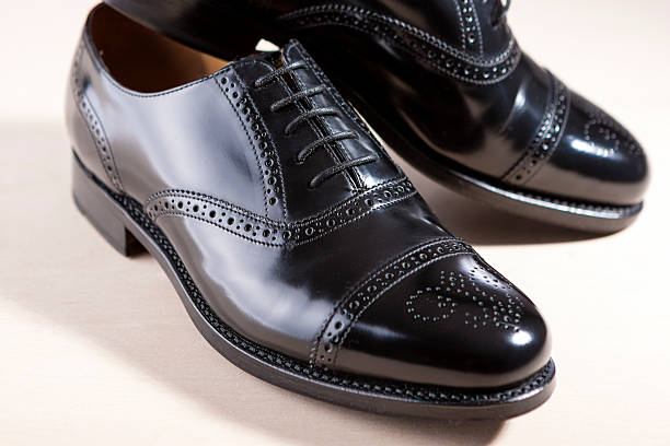 Pair of Black Fashionable Male Oxfords Semi-Brouge Laced Shoes Footwear Concept. Pair of Black Fashionable Male Oxfords Semi-Brouge Laced Shoes. Horizontal Image brogue photos stock pictures, royalty-free photos & images