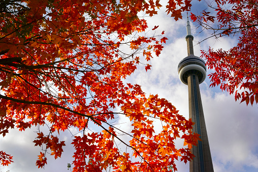 September 2023- Toronto, Canada: View on the Canadian National - CN - Tower (communications tower), taken from downtown Toronto, with Union Station in front. Also features beautiful skies shortly after rain and the beginning of sunset.