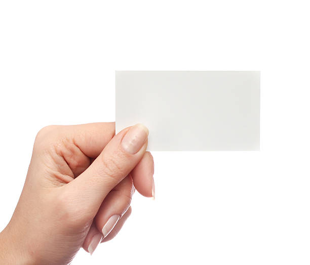 istock Female hand holds business card on white background 507717700