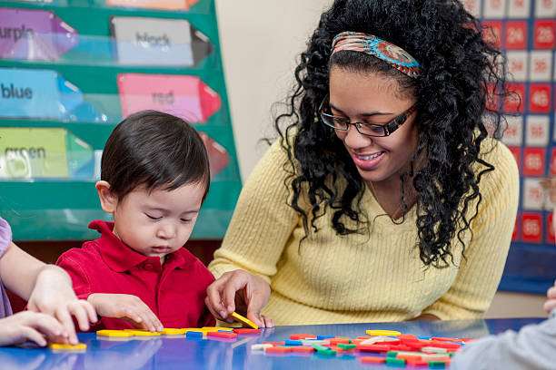 istock Teacher Helping a Student with a Crafts 507718124