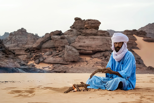 Akakus Mountains, Libya - November 03, 2007: Tuareg in the desert Akakus Mountains, it makes a campfire for the night.