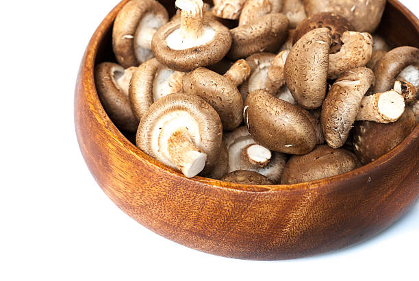 istock Fresh mushrooms in bowl on wooden background 507720265