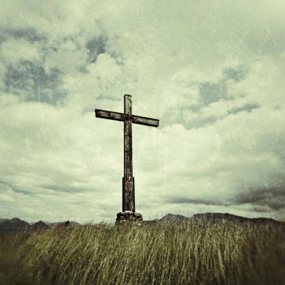 Vintage Image: Cross in front of blue sky with clouds