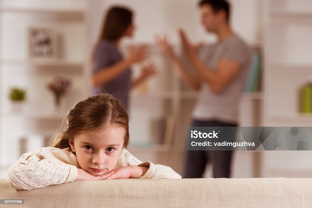 Quarrels upset child Ð¡hild suffering from quarrels between parents in the family at home Family Stock Photo