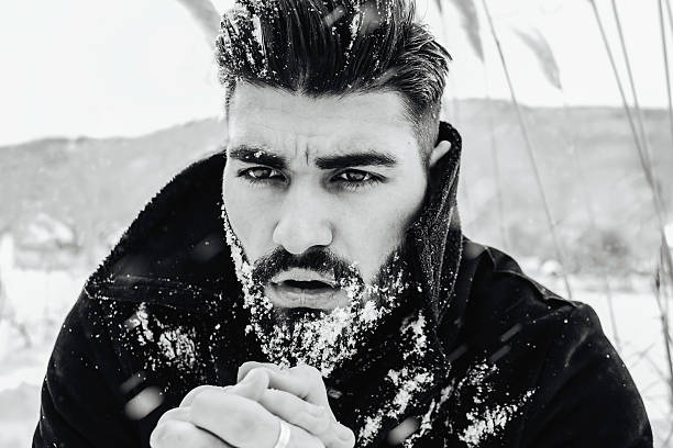 istock Bearded man in snow storm warming his hands 507721384