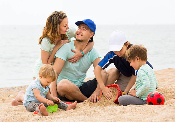 istock Happy parents smiling with children resting at sea 507721421