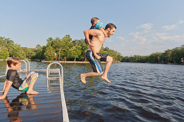 istock Father and two sons enjoying Summer at the Lake 507721619