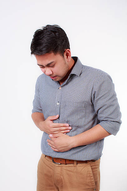 istock man with strong stomach pain 507723155