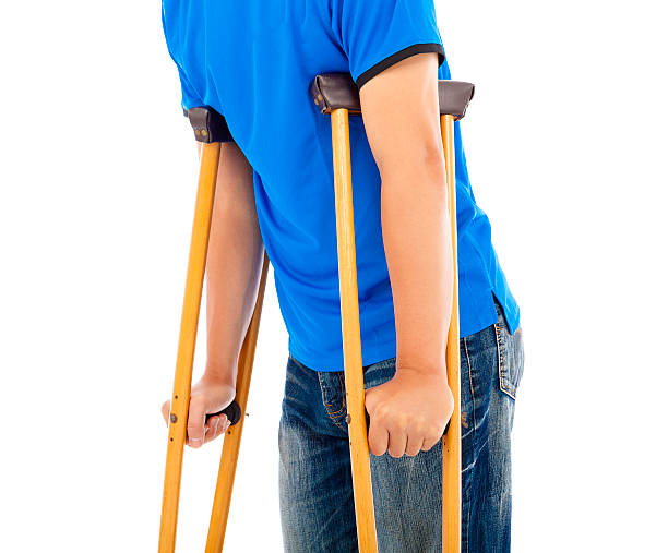 istock close up of young man on crutches. 507723579