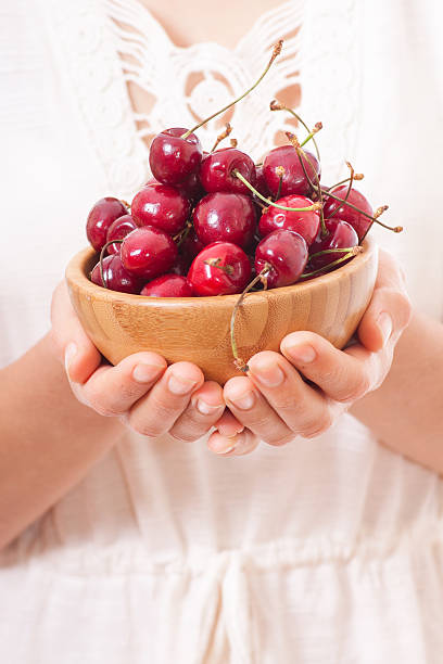istock Crockery with cherries in woman hands. 507725801