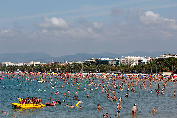 People relaxing and having fun on the beach of Salou, Spain