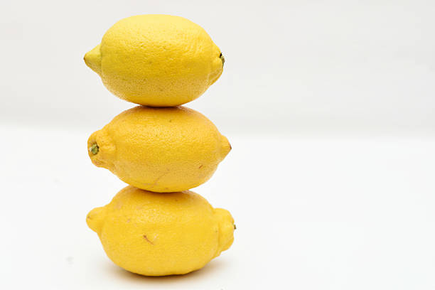 bowl of ripe lemons on white background