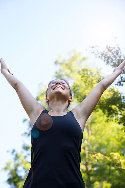 istock Young beautiful woman with hands raised in the park 507743232