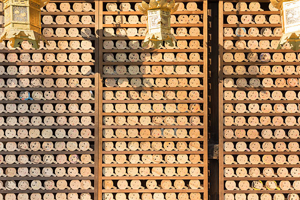 Kyoto, Japan - December 31, 2015: Kawai Shrine has been enshrined female guardian. Woman pray and makeup to \