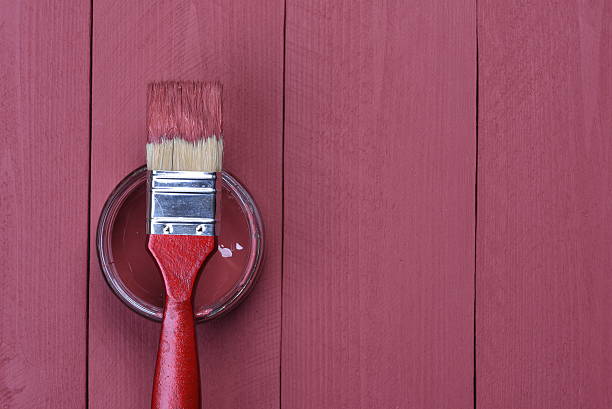 istock Pink paint can with brush on wooden background 507745350