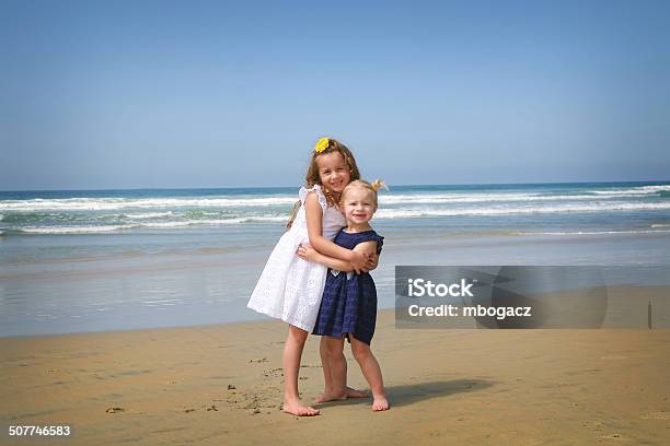 Sisterly Love Beach Scene Stock Photo - Download Image Now - 18-23 Months, 4-5 Years, Baby - Human Age