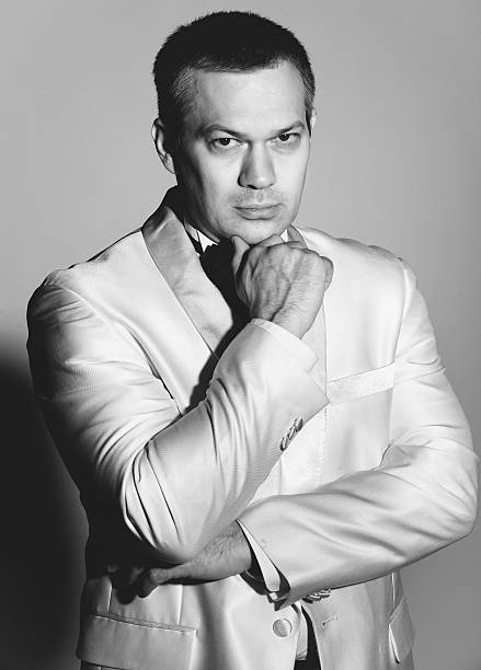 istock sexy man in white jacket holding hand on chi 507746857