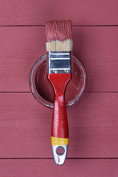 istock Pink paint can with brush on wooden background 507747000