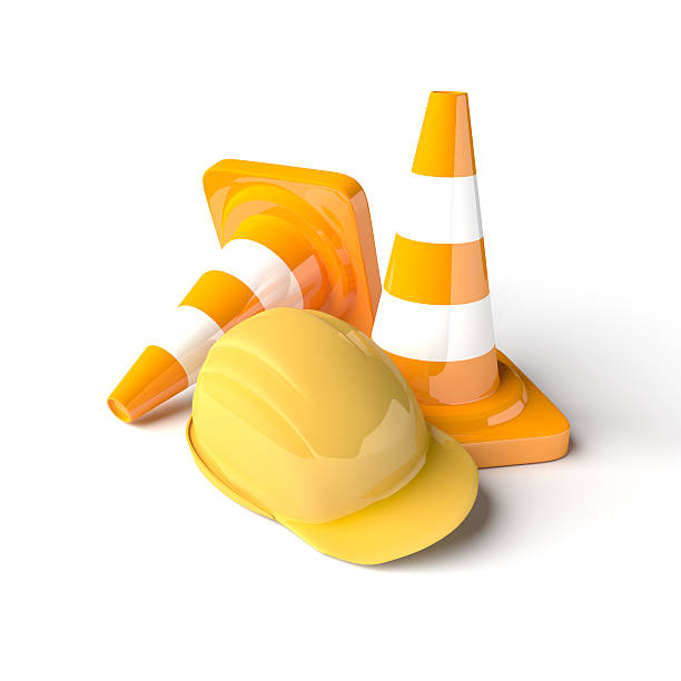 istock Traffic cones with work helmet isolated on the white. 507748386