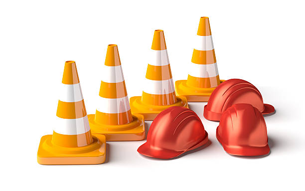 istock Traffic cones with work helmet isolated on the white. 507748458