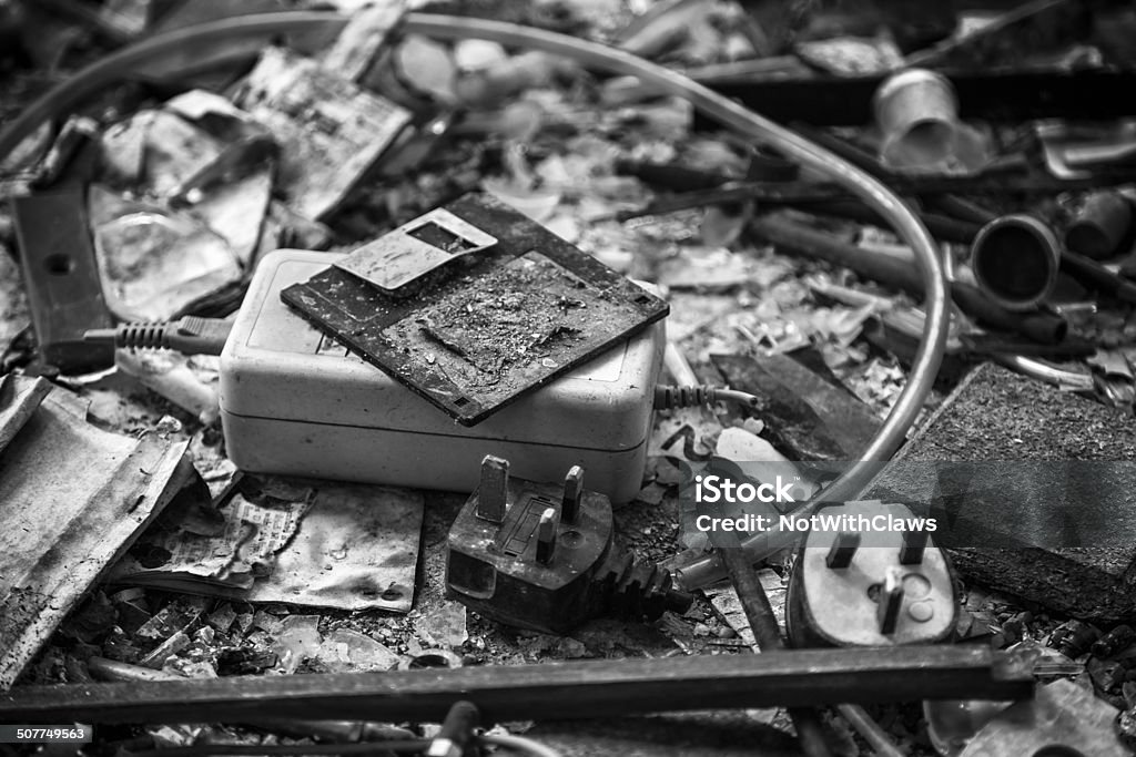 Charred remains of floppy disk and office equipment Floppy disk, mains lead with UK 3 pin plug, power supply transformer, burnt documents and other office items after a fire Office Stock Photo