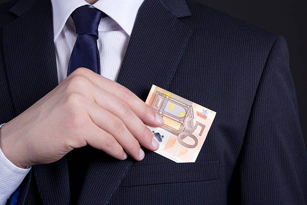 istock business man hand putting euro banknote into suit pocket 507750302