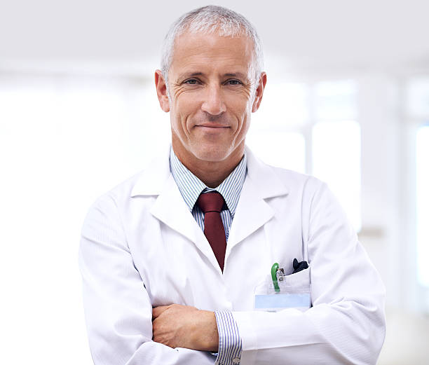 let him help you get healthy - doctor male doctor mature men portrait 뉴스 사진 이미지