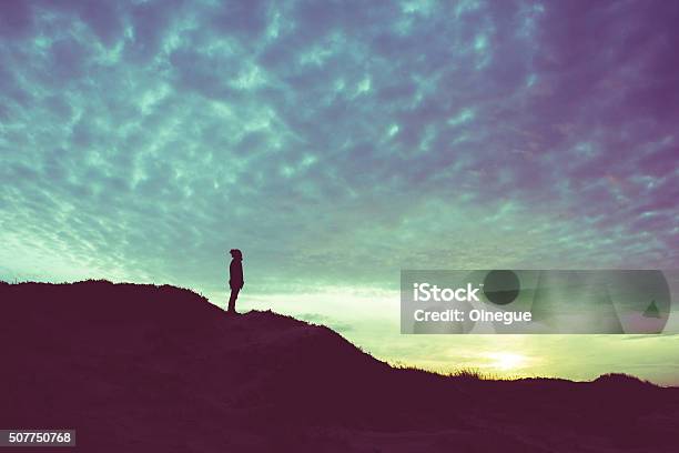 Back Light Silhouette Of A Man Standing On A Hill Stock Photo - Download Image Now - Looking Over, Hill, In Silhouette