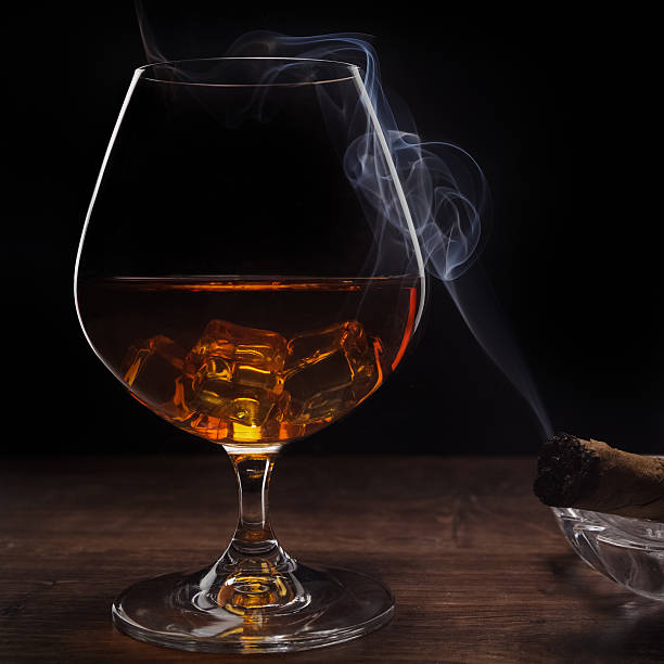istock whiskey and smoking a cigar 507750832
