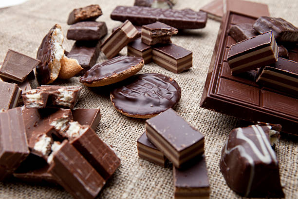 istock Broken chocolate bar and spices on wooden table 507752069