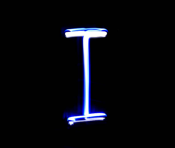 istock I Item alphabet hand writing blue light  over black background. 507752282