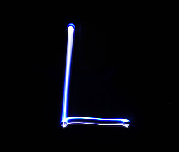istock L Lima alphabet hand writing blue light  over black background. 507752392