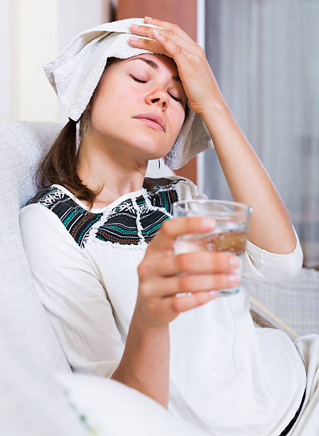 istock Woman with headache at home 507754646