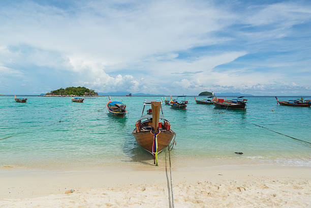 istock Long tail boats lined with blue sky at Koh Lipe. 507754654