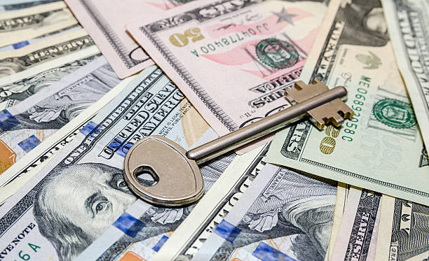 istock house key above american one hundred dollar bills 507755384