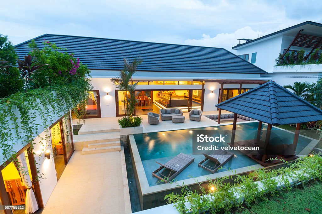 Modern tropical villa A modern island villa with open living room, swimming pool, gazebo Swimming Pool Stock Photo